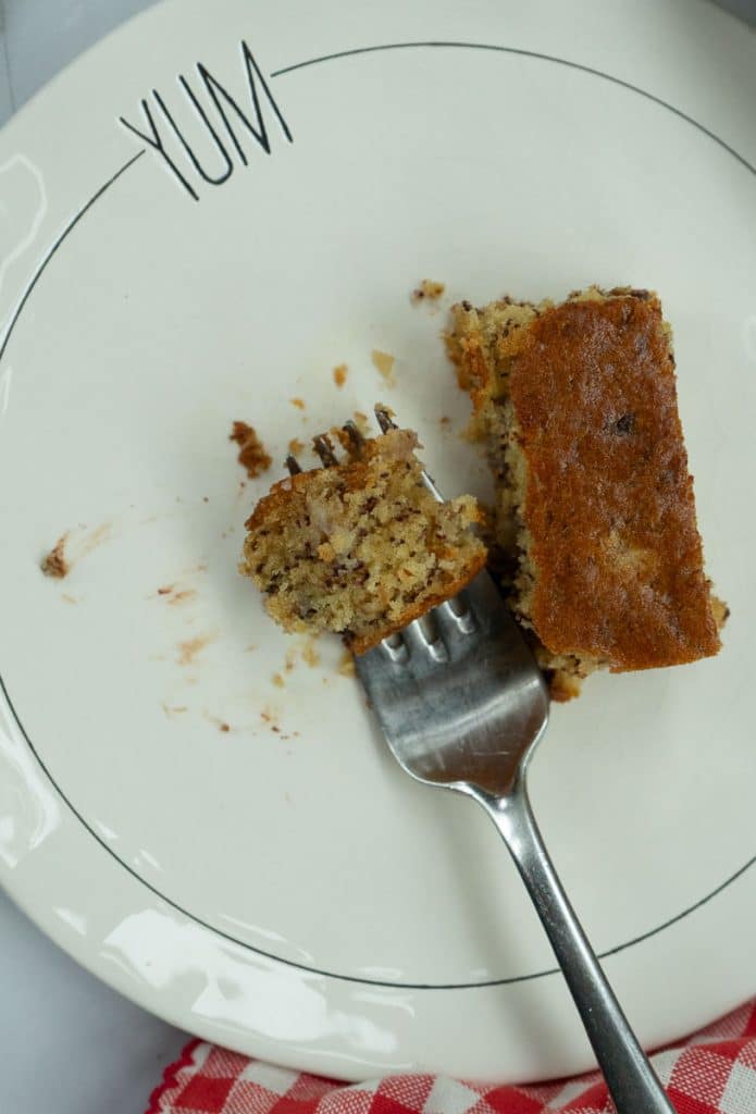 piece of banana snack cake half eaten on a plate with a fork