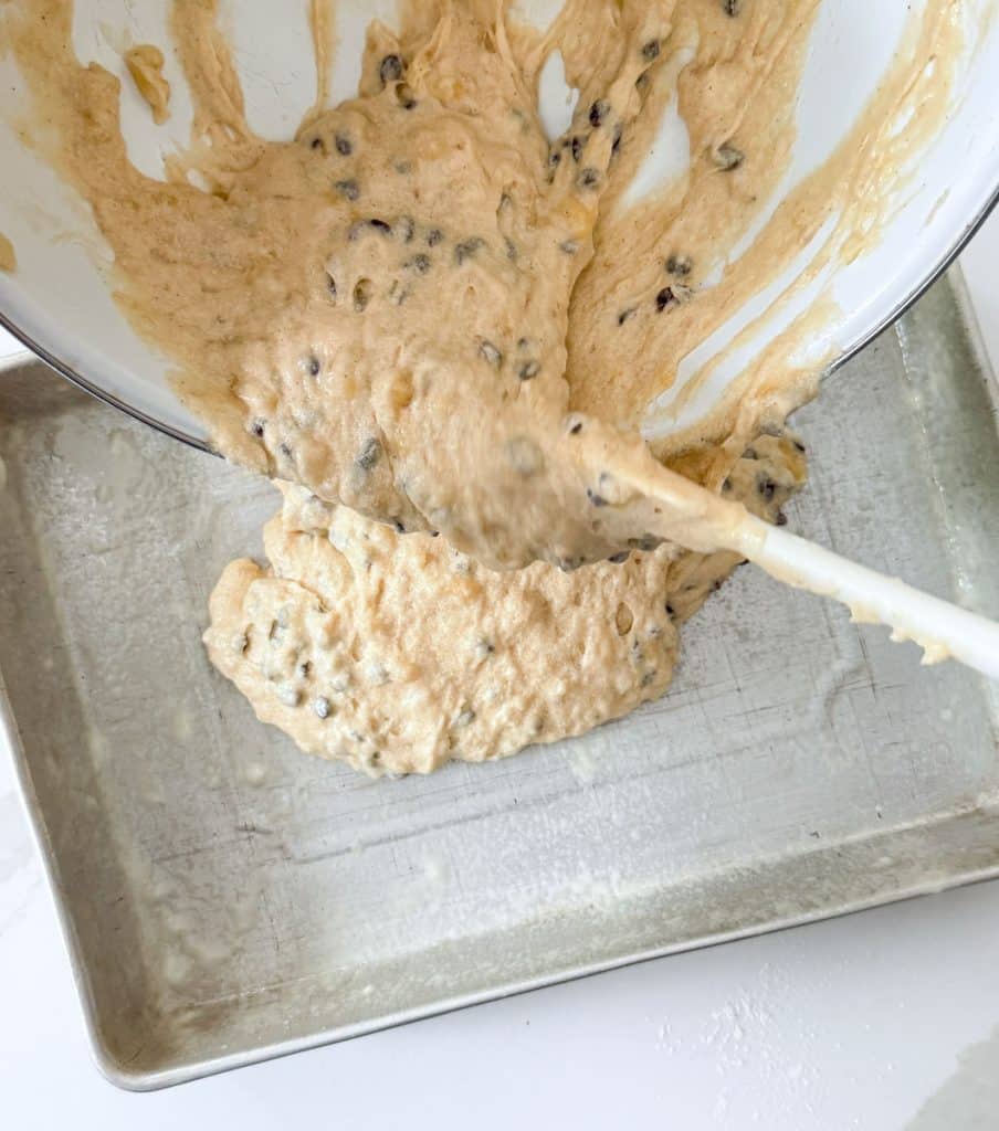 putting cake batter in 9x13 cake pan