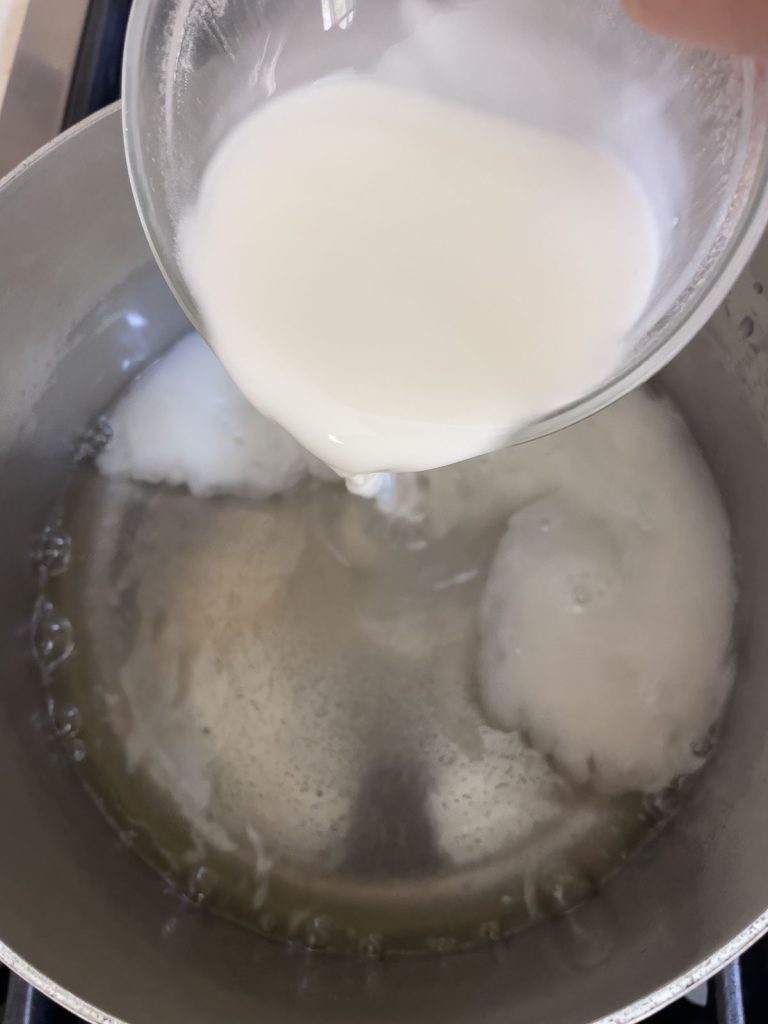 adding cornstarch slurry to the syrup in a sauce pan