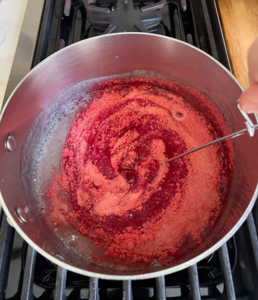 strawberry jello added to thickened sugar water, creating a beautiful red swirl