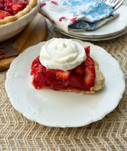 piece of fresh strawberry pie on a white plate