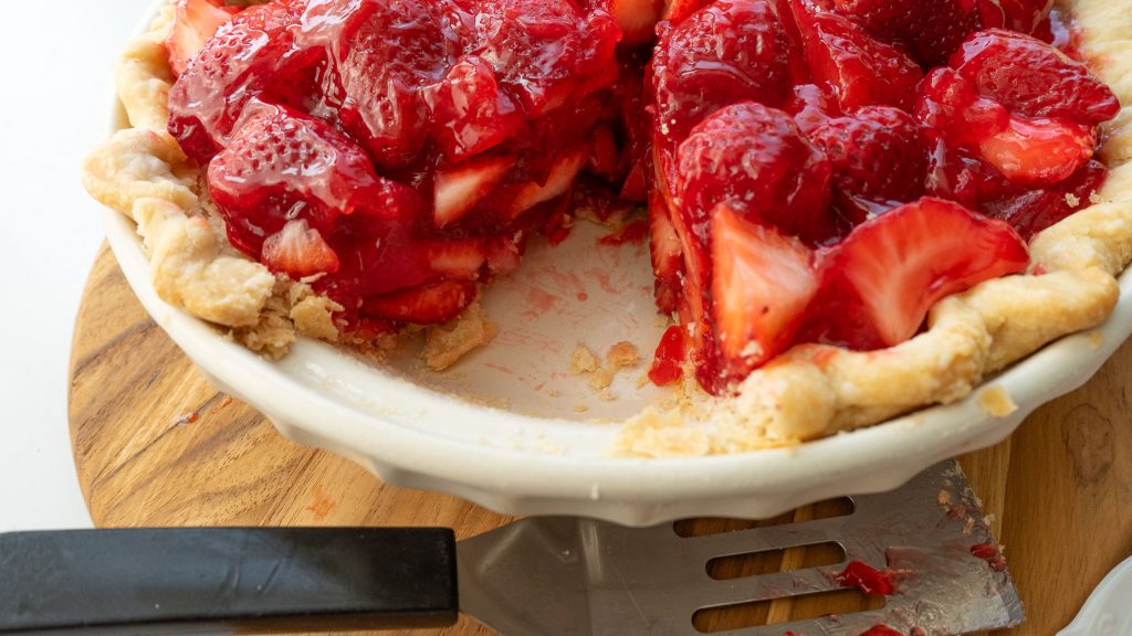 fresh strawberry pie with a piece cut out