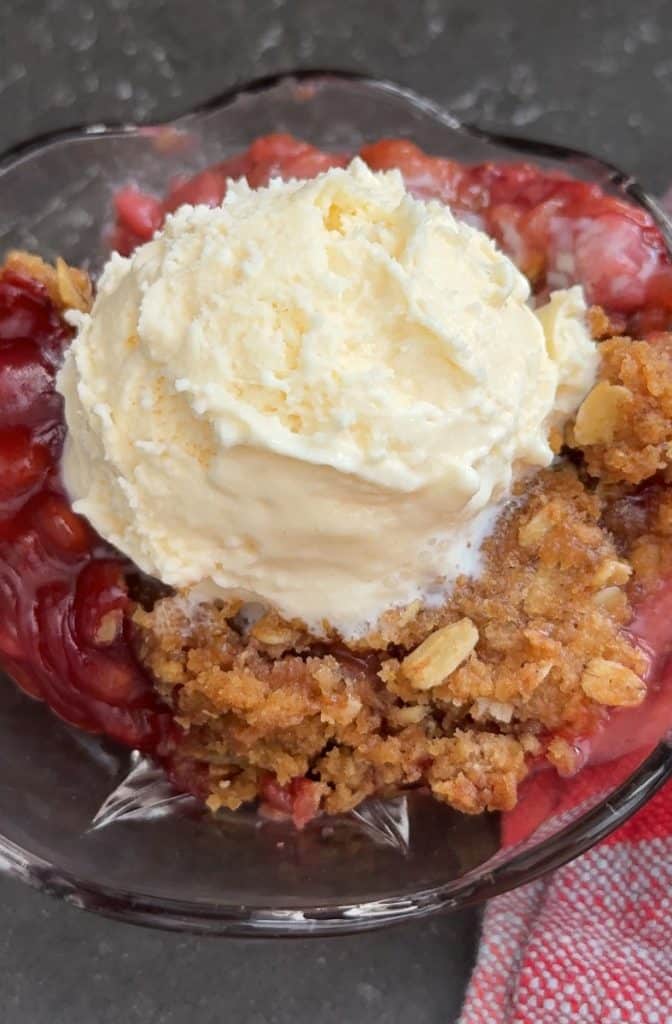 bowl of crisp with a scoop of vanilla ice cream on top
