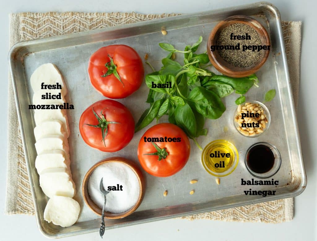 ingredients for caprese salad on a baking sheet