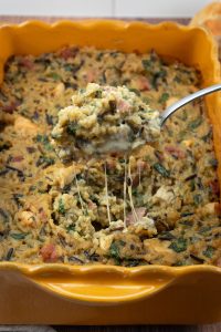 chicken and rice cheesy casserole, spoon serving scooping chicken and rice out of dish