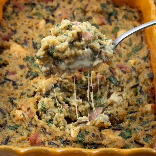 chicken and rice cheesy casserole, spoon serving scooping chicken and rice out of dish