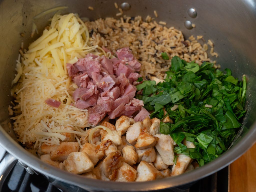 wild rice, cheese, chicken, ham , spinach in pan 