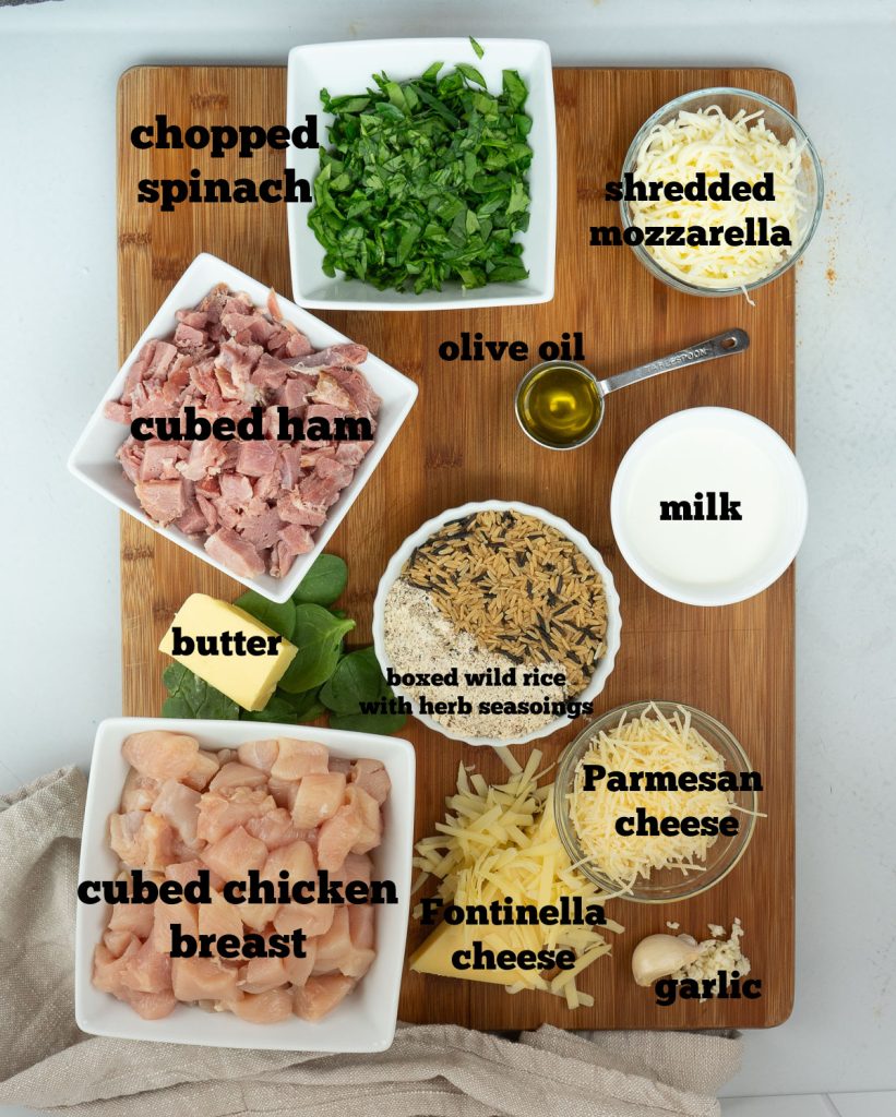 ingredients for chicken fontinella on a wood cutting board