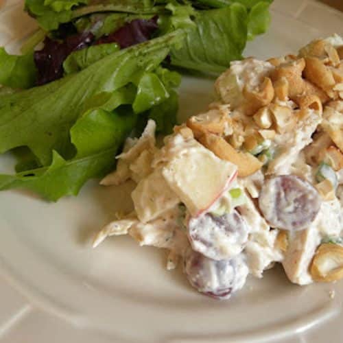 curry chicken salad on a plate with green salad