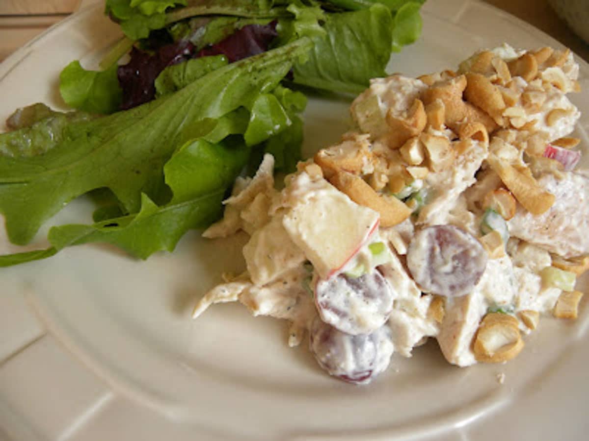 curry chicken salad on a plate with green salad