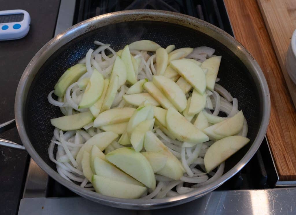 onions and apples in a skillet on the stove top
