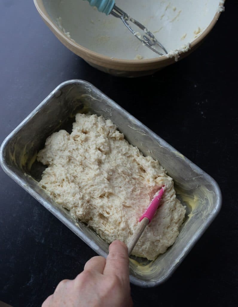 spreading batter into a buttered bread pan