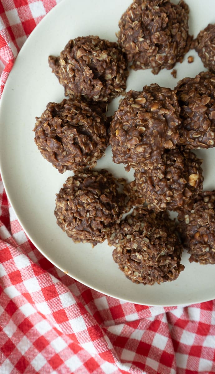plate of no bake cookies sitting on a red and white cloth