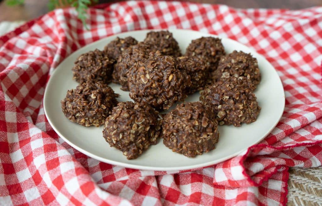 plate of no bake cookies sitting on a red and white cloth