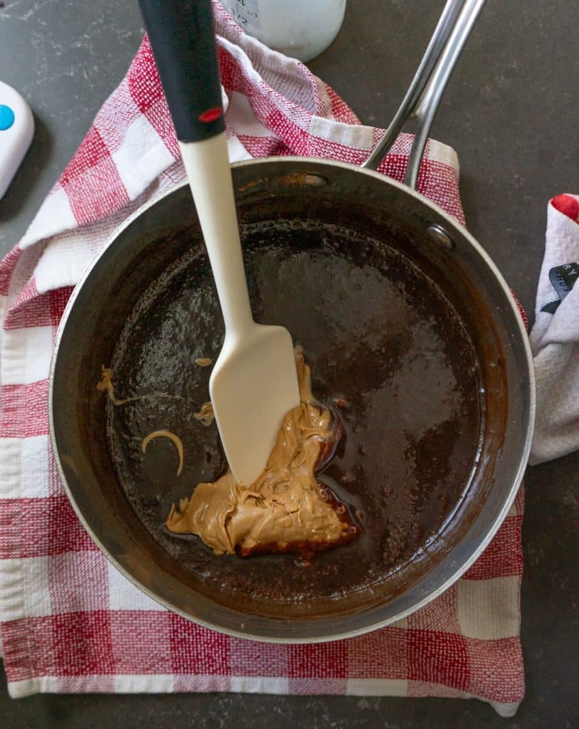 adding peanut butter to the chocolate cookie mixture