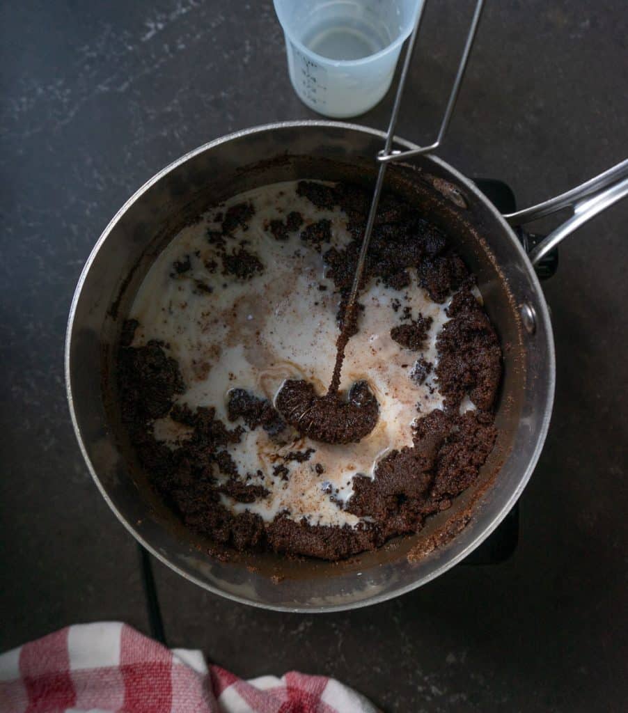 adding milk to chocolate mixture there is a whisk in the pan