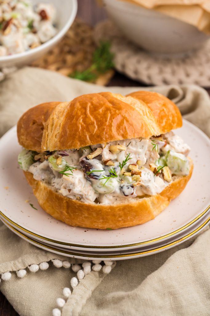 chicken salad croissant on white plate