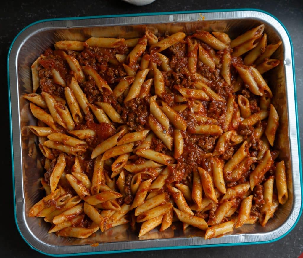 pasta and red sauce dish setting on counter before baking