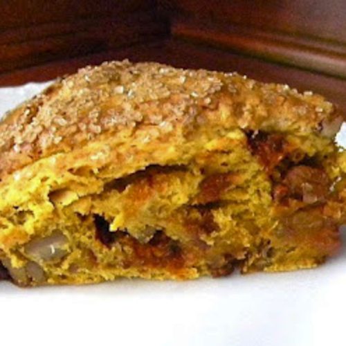 loaded pumpkin scone on a white plate