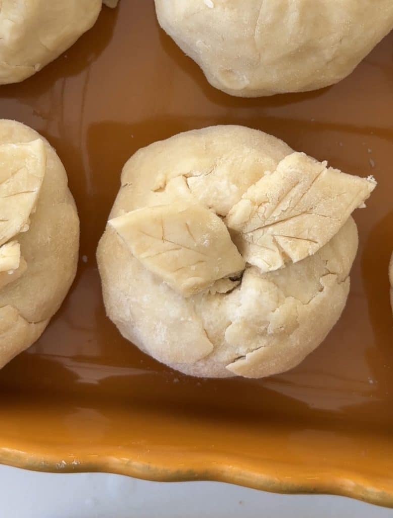apple dumpling in baking dish before being baked
