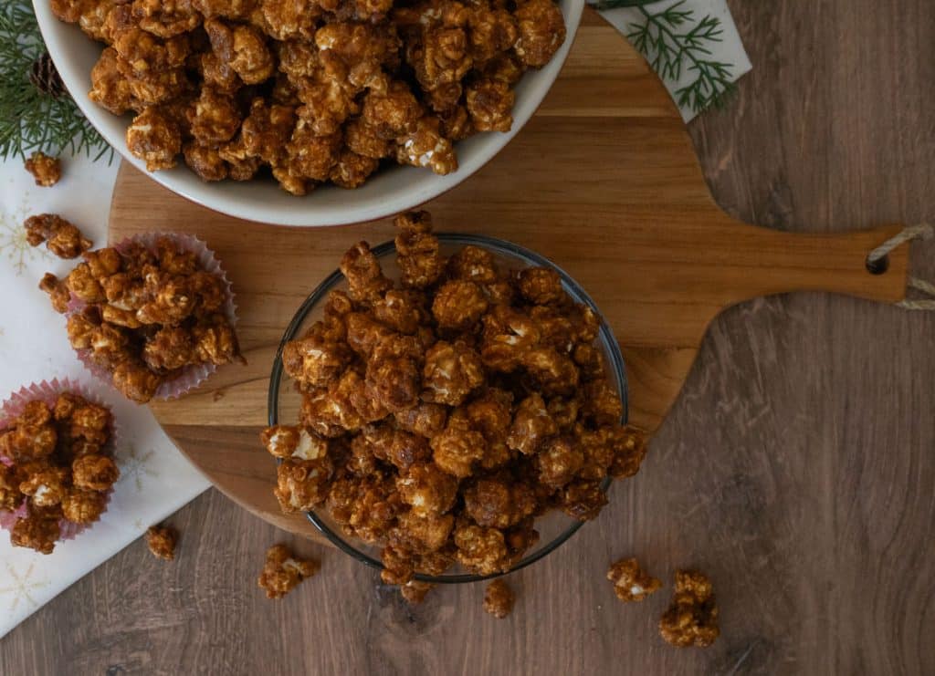 arial view of bowls of caramel corn on a wood cutting board