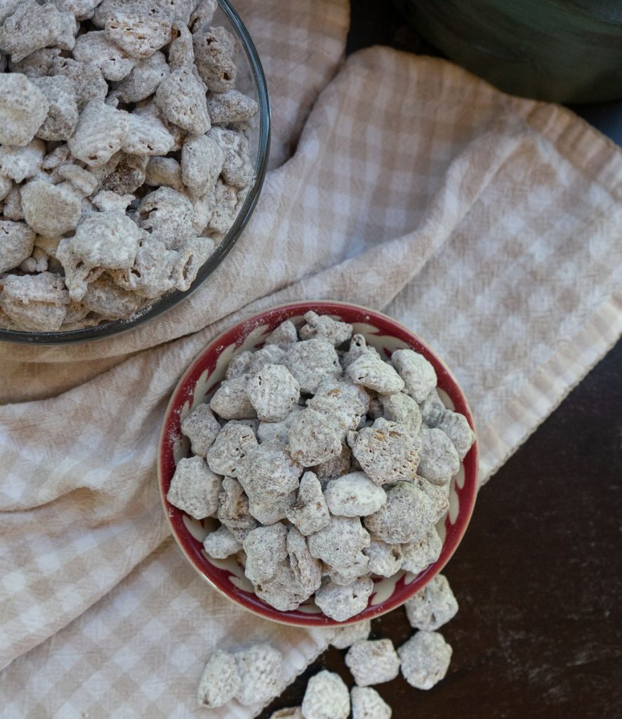 arial view of puppy chow on a tan and white gingham cloth on a black table