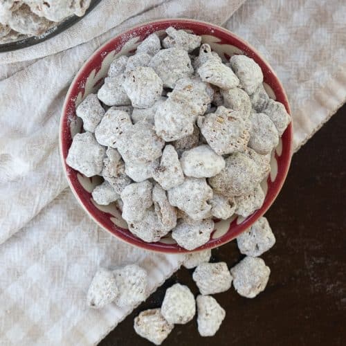 arial view of puppy chow on a tan and white gingham cloth on a black table