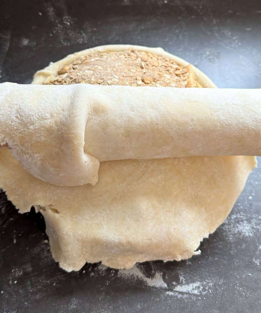 rolling second crust over top of the crumble layer