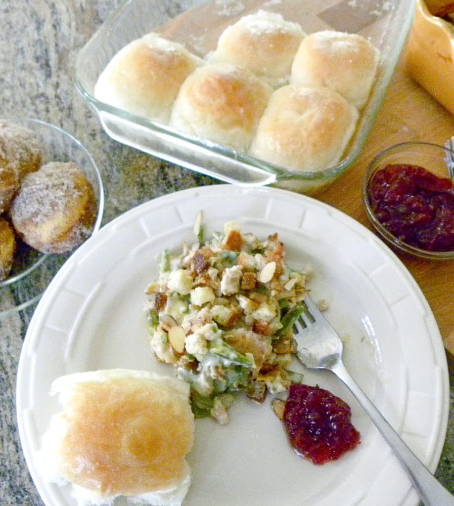 3-11-227 plated chicken supreme with a dinner roll and a spoonful of cranberry sauce on a plate with a fork