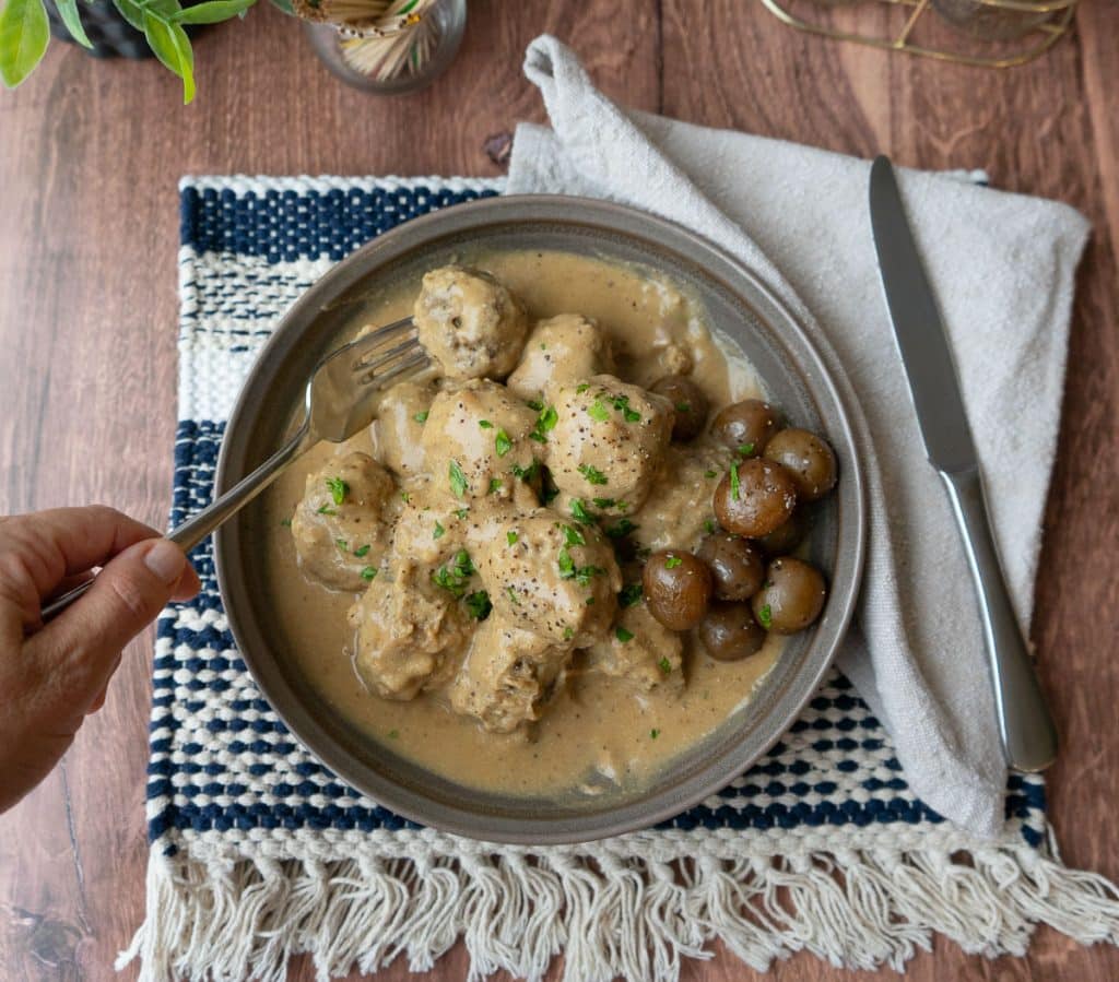 top view of a plate of swedish meatballs with boiled potatoes