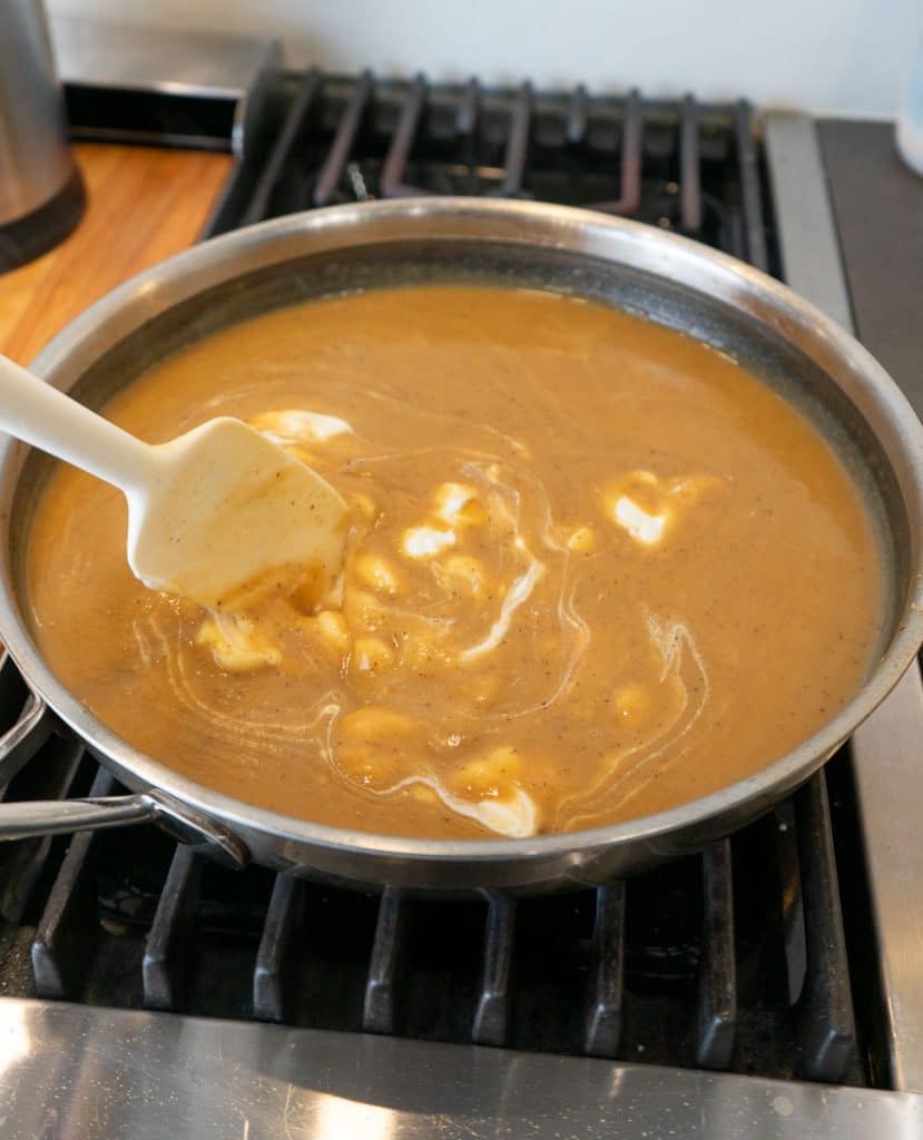 stirring sour cream into the swedish meatball gravy