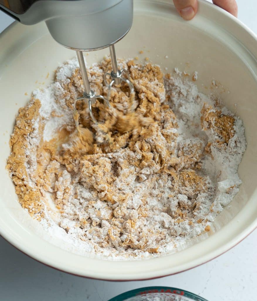 DSC00614 peanut butter, butter, and powdered sugar being mixed in a bowl with a hand mixer