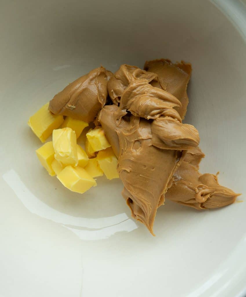 peanut butter and butter measured into a glass ceramic bowl