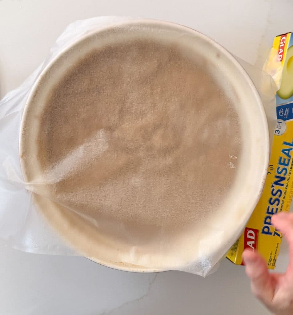 covering bowl of bran muffin mix with plastic wrap 