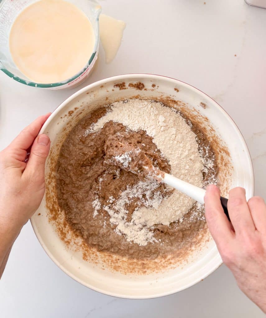 adding flour/ dry ingredients to the large bowl with bran mixture in it. 