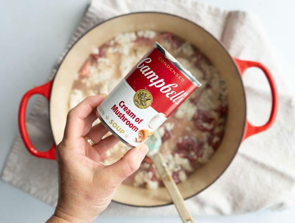 adding cream of mushroom soup over top of stew meat