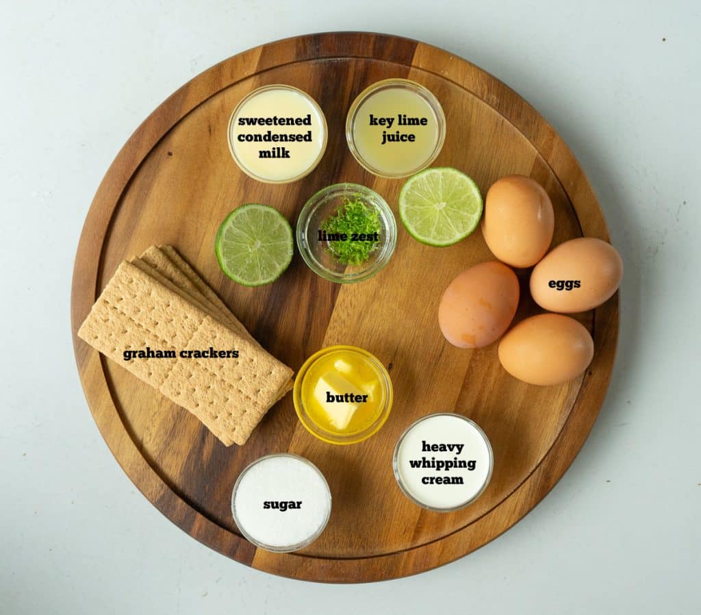 ingredients for key lime pie on a wood board
