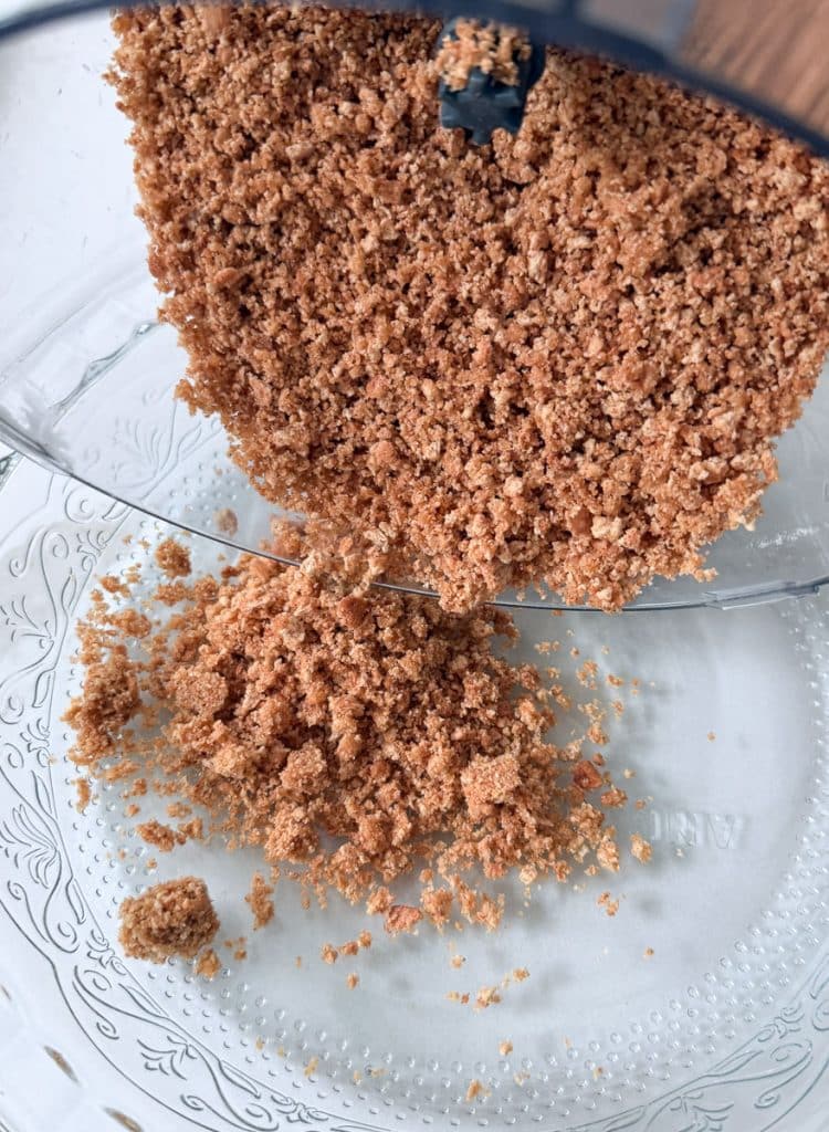 pouring graham cracker crust into pie plate