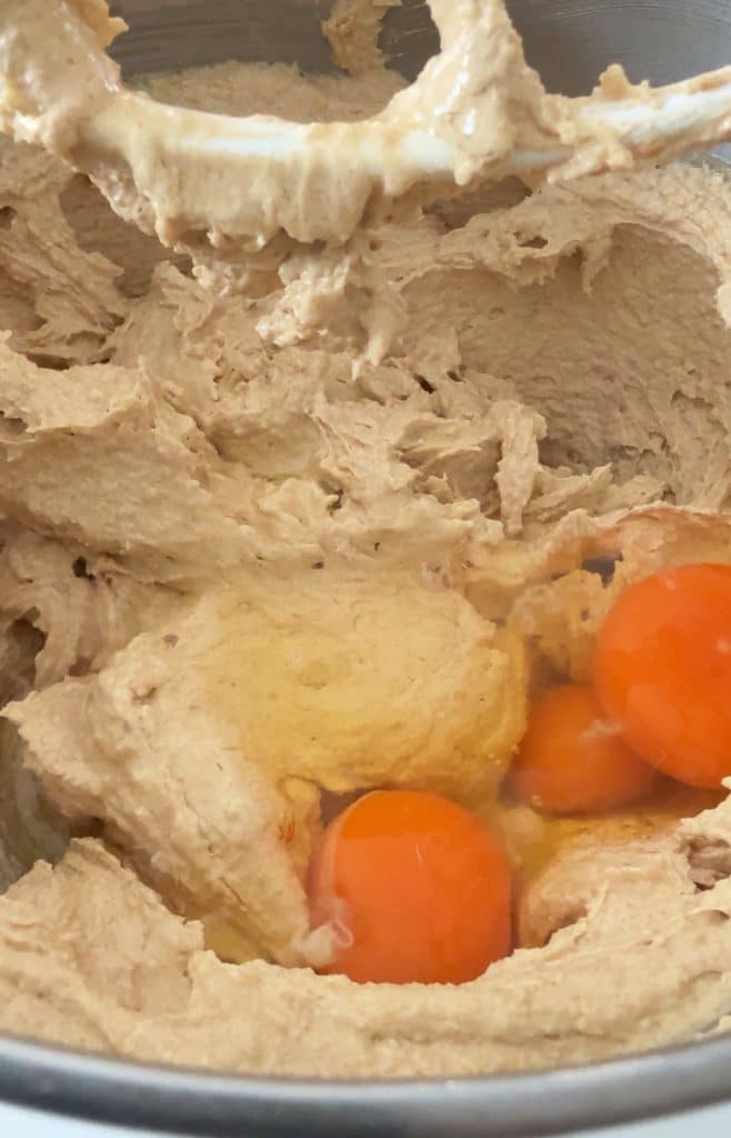 adding eggs to the peanut butter and butter mixtrue