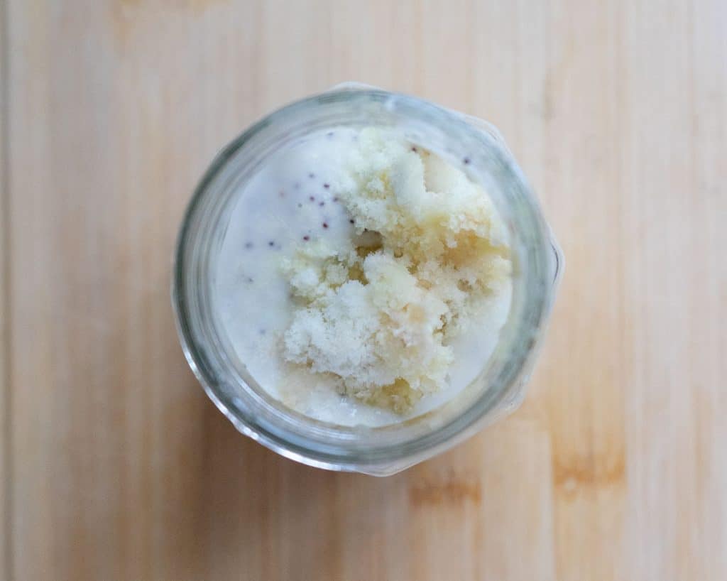 jar with poppyseed dressing and garlic and ginger added to it