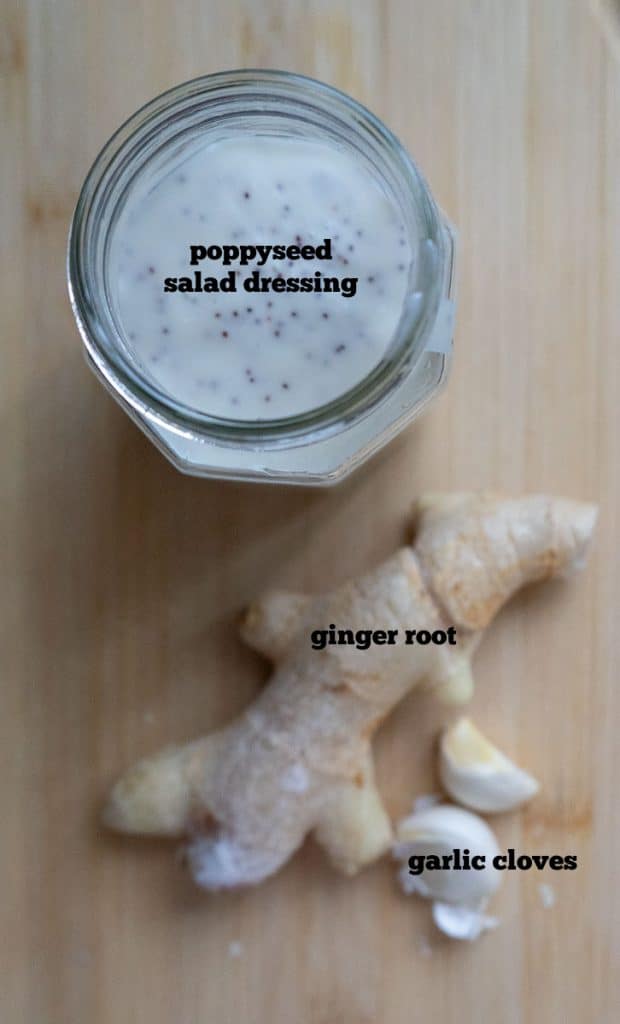 ingredients for the salad dressing on a wood cutting board