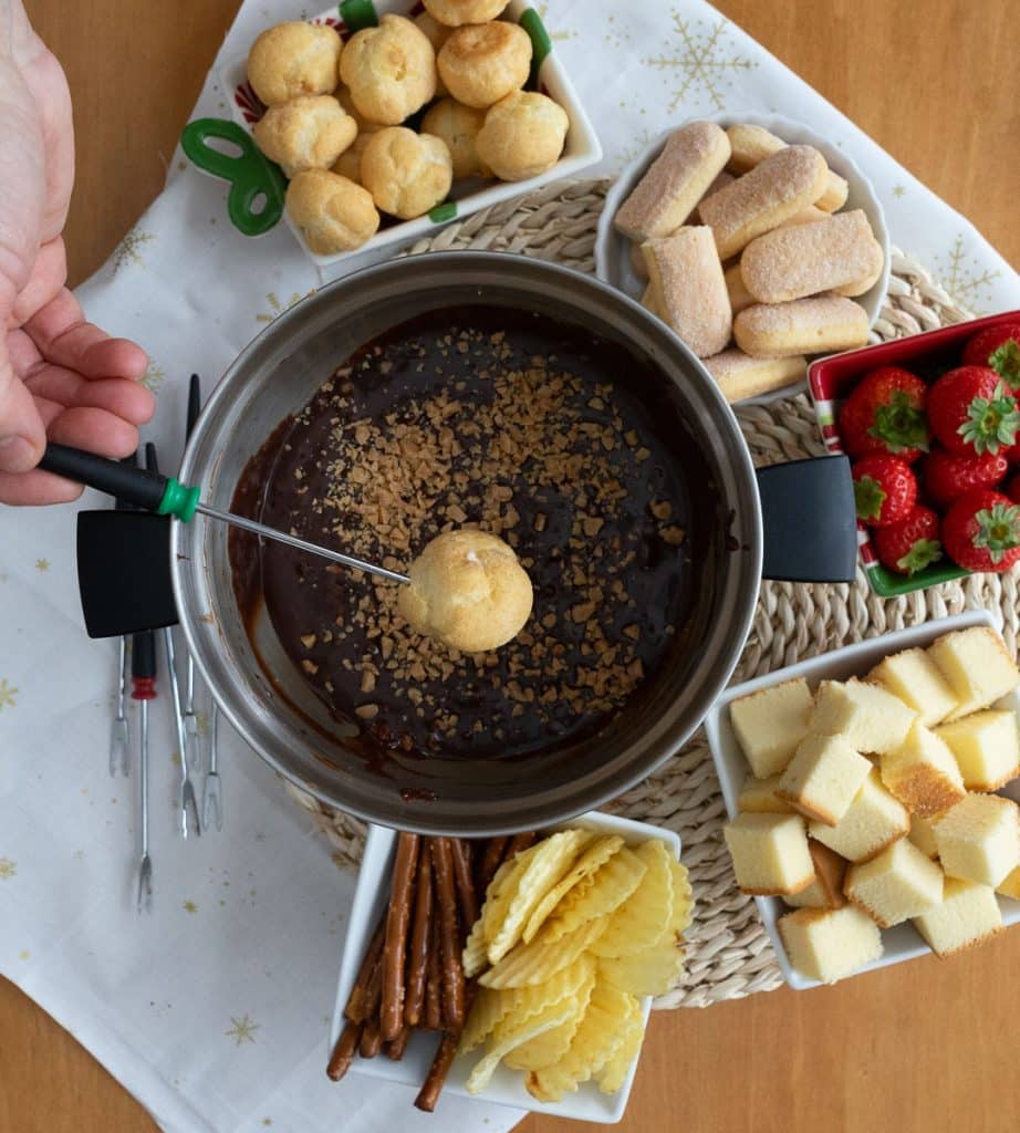 dipping a cream puff into the chocolate fondue