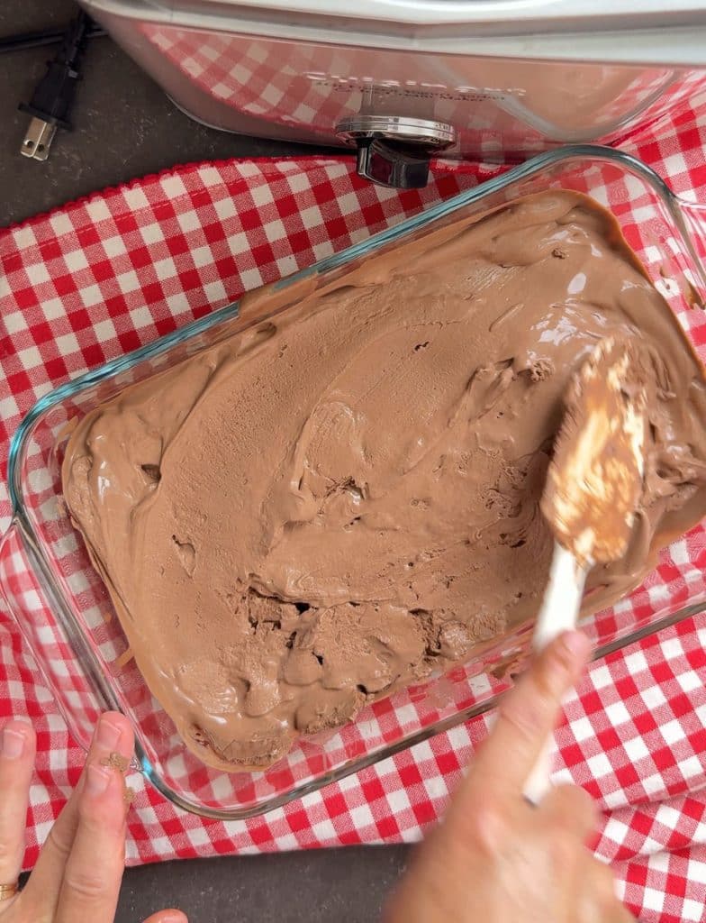DSCN8301 placing ice cream in a freezer safe shallow container smoothing out the surface with a spatula