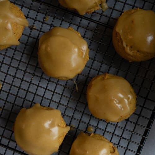 frosted pumpkin spice cookies on a wire cooking rack