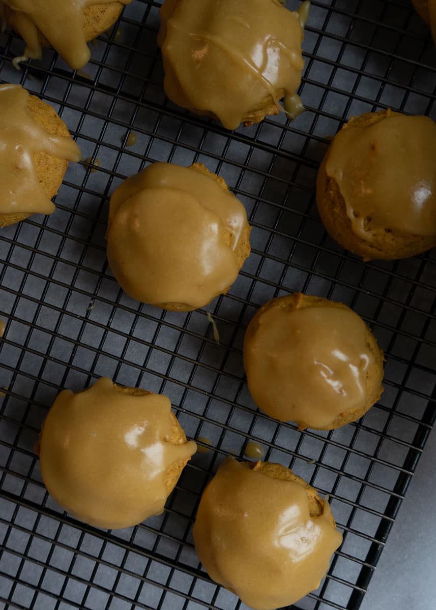 frosted pumpkin spice cookies on a wire cooking rack