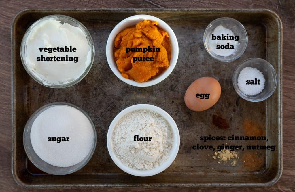 ingredients for pumpkin spice cookies on a baking sheet