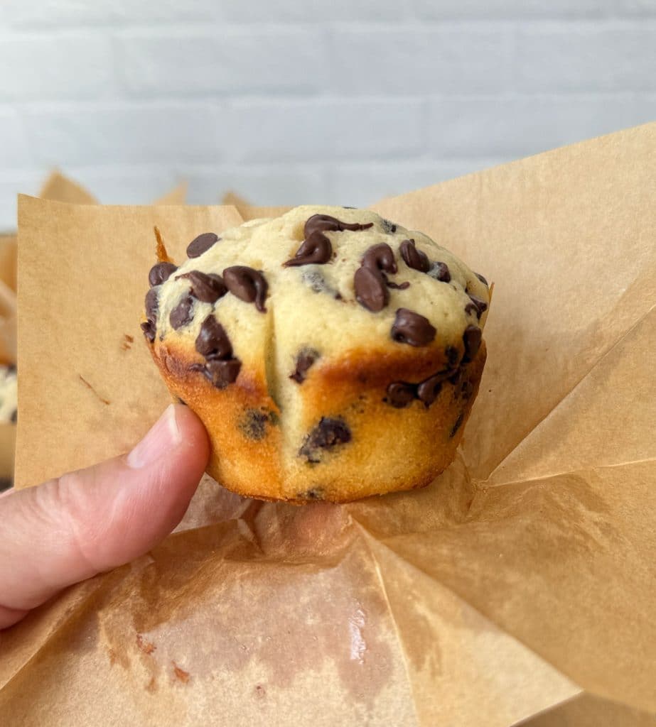 IMG_3946 chocolate chip muffin held in hand being unwrapped from muffin cup