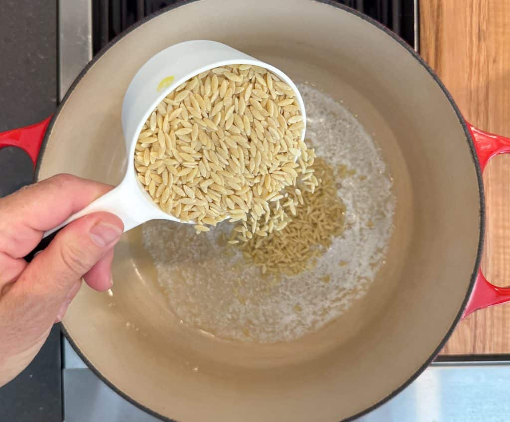pouring orzo into melted browning butter