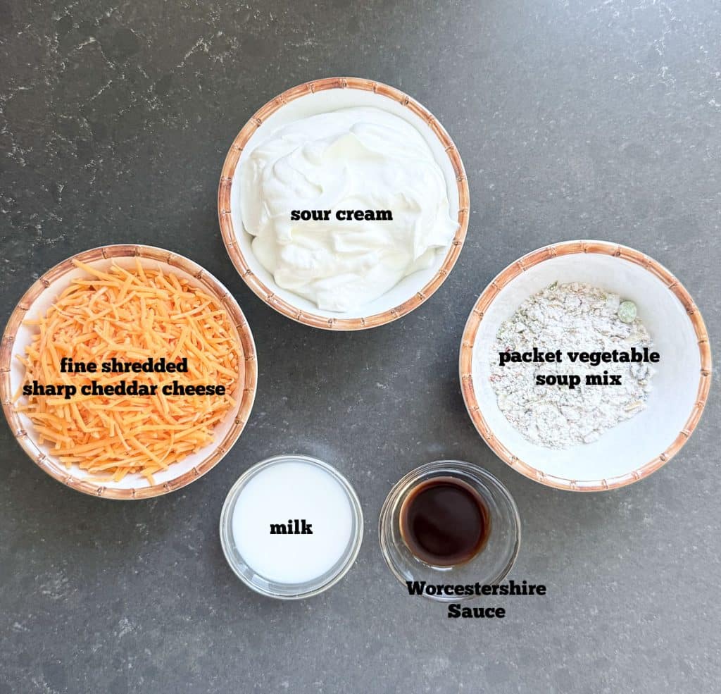 ingredients for easy cheesy vegetable dip on black countertop