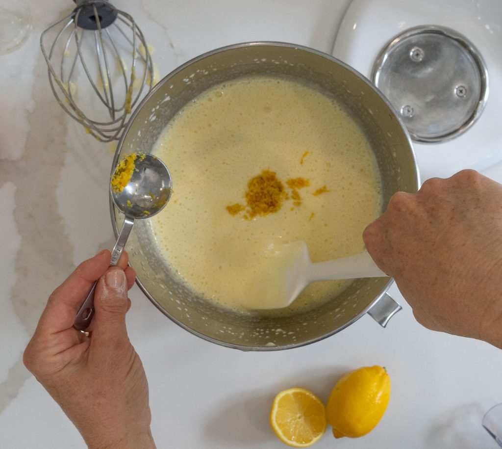 folding lemon zest into the lemon bar filling with a spatula